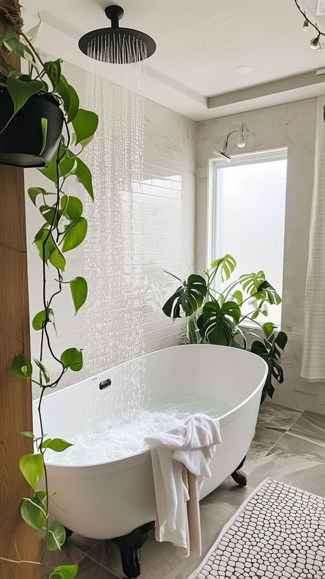 Serene bathroom oasis with a freestanding bathtub, bubbles, green plants, and rain showerhead - ideal for relaxation and tranquility at home Standalone Bathtub Decor, Master Bathtub Decor Ideas, Master Bathtub Decor, Bathroom Greenery, Bathroom With Plants, Stand Alone Bath Tub, Master Bathtub, Home Retreat, Relaxing Home