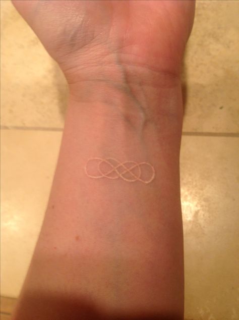 White ink double infinity tattoo - if I ever get a tattoo i want to get that and under it say beautiful. Infinity Tattoo On Finger, Double Infinity Tattoo, Tattoo White Ink, Someday Tattoo, Gold Tattoo Ink, Double Infinity Tattoos, Adoption Tattoo, Tattoo On Finger, Infinity Tattoo On Wrist