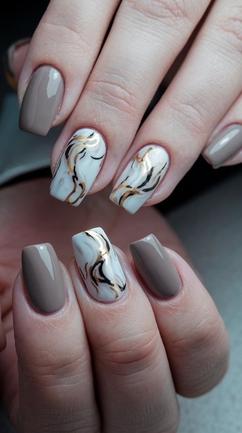 Discover the ultimate in chic nail art with this stunning taupe base featuring a sophisticated marble effect in soft white and subtle black accents. Enhanced with luxurious metallic gold swirls, this design embodies elegance and versatility, making it perfect for both casual outings and special events. Whether you're sipping coffee with friends or attending a glamorous evening affair, these nails are sure to make a statement. #nailsdesign #acrylicnails #septembernails #fallnails #autumnnails Marble Nails With Gold, Taupe Nails, Nails With Gold, Chic Nail Art, September Nails, Sipping Coffee, Coffee With Friends, Casual Nails, Marble And Gold