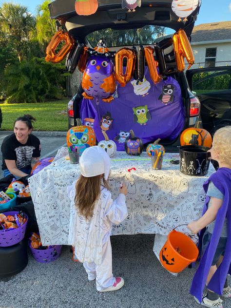 a trunk of an suv is decorated with images of owls dressed in halloween costumes with a purple backdrop. children are trick or treating in front of the trunk Owl Trunk Or Treat, Trunk Or Treat Twister, Stuffed Animal Trunk Or Treat, Twister Treat Trunk Or Treat, Trunk Or Treat Bank Theme, Owl Nest, Tootsie Roll Pops, Happy Owl, Trunk Or Treat Ideas