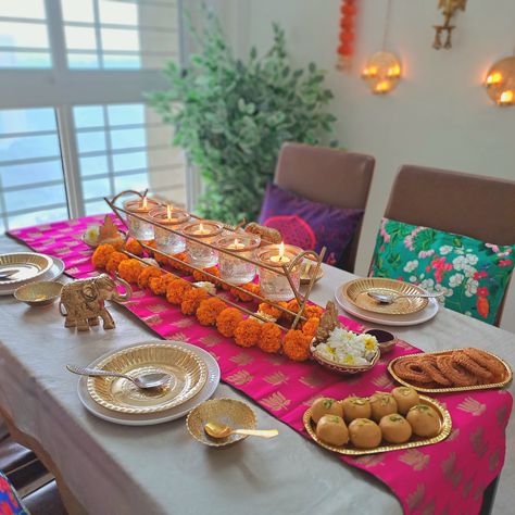 This dining area becomes a canvas that showcases the rich heritage and customs of India. A splash of royal colors adorns the table, reflecting the opulence and grandeur of Indian traditions. Intricately designed decor in golden accents, such as candle holders, placemats, or decorative plates, add a touch of glamour and elegance to the space. An array of beautiful candles and flowers grace the dining table, completing the immersive experience. Cr: mera_ashiyana2022 Dining Table Indian, Dining Table Decor Indian, Candles And Flowers, Buy Dining Table, Dining Table Sets, Dining Table And Chairs, Royal Colors, Table Sets, Chairs Dining