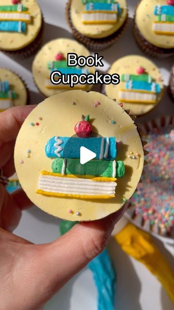 Alex LaRosa on Instagram: "Back to School Books 📚   ✨start with your flat top cupcake   ✨using straight petal tip 102/103 pipe your books  ✨I like piping them askew to look like a realistic stack   ✨use a basket weave tip to pipe the book pages   ✨pipe a round apple on top, don’t forget your stem, leaf and shine line  Supplies @nycake Sprinkles  Piping tips Colors .  . . . . . #alexlarosabakery #backtoschoolcupcakes #bookcupcakes #bookstack #colourmillmade #yellowcupcakes" Book Club Cake, Cupcake Flat Top, Book Cupcake Toppers, Book Worm Cake Ideas Birthday, Storybook Cupcake Toppers, Cupcakes Books Theme, Back To School Books, Book Club Parties, Book Cupcakes