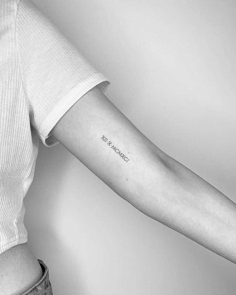 Tiny Roman numerals by Conz Thomas inked on the left arm Roman Numeral Minimalist Tattoo, Roman Numeral Tattoo Bicep, Arm Women Tattoo, Minimalist Tattoo Women, Tattoo Date, Roman Numbers Tattoo, Bicep Tattoo Women, Date Tattoo, Roman Numeral Tattoo