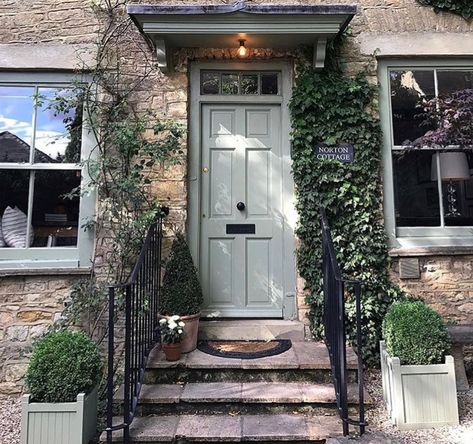 Check out this wonderful photo of an English cottage where the stunning front door was painted in the color Lichen by Farrow & Ball in Exterior Eggshell. It is just so welcoming.  Visit ThomasMachInteriors.com for more inspiration.  #farrowandball #farrowandballpaint #homedecor #homedecorideas #inspiration #interiordesign #interiordesignideas Cottage Front Door, Farrow Bal, Cottage Front Doors, Ideas Entryway, Front Door Paint Colors, Door Colors, Door Paint Colors, Paint Color Inspiration, Door Canopy