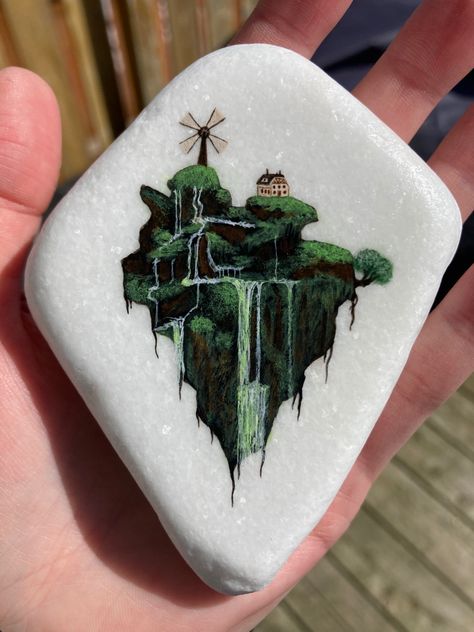 Floating island painted on santorini stone Floating Rock Tattoo, Painted Santorini Stones, Snail Tattoo, Manitoulin Island, Stone Paint, Rock Tattoo, Floating Island, Painted Rock, Art Stuff