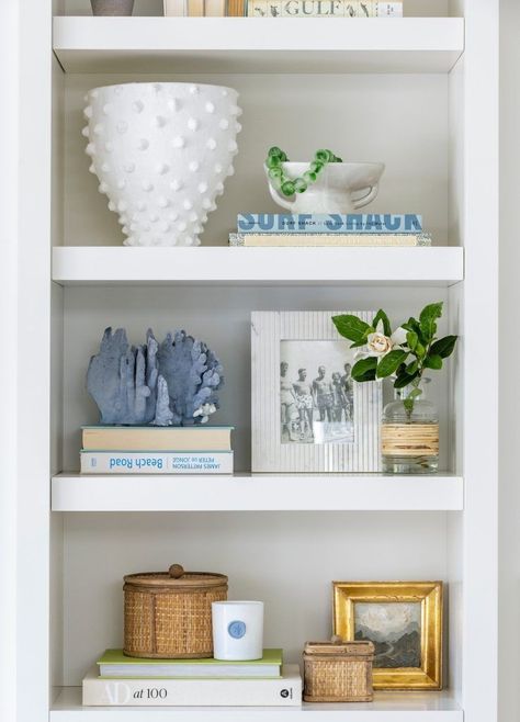 These home decor projects are so easy and they are sure to transform your space. Tap for the details. Coastal Book Shelf, Interior Design Shelf Decor, Styled Office Shelves, Living Room Shelving Decor Ideas, Coastal Bookshelf Styling, Coastal Bookcase Styling, Blue And White Shelf Decor, Traditional Bookshelf Styling, Built In Bookshelf Living Room