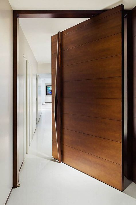 A large pivot door of an apartment in an #indian home. #indianhome #entryway #designideas #interiordesign #decorideas Tor Design, House Main Door, Modern Entrance Door, House Main Door Design, Single Door Design, Main Entrance Door Design, Front Door Design Wood, Pivot Door, Wooden Main Door