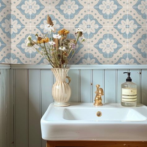 Embellish your home with a touch of modern folk charm with our Larkspur wallpaper in Powder Blue. Embracing the essence of cottage core and French country aesthetics, this design features a captivating dusty blue hue and a delicate floral print. Perfect for the free-spirited decorator, Larkspur brings a fresh, airy vibe to any room. Transform your bathroom with ease and let Larkspur tile stickers add a touch of whimsy to your decor. Explore the beauty of modern folk style and let your space bloom with Larkspur. ColoursThe pattern blends a mix of powder blue & bone white with a hand-painted chalky texture effect. Tile SizeEach tile square is 6" x 6" (15 x 15cm) Farmhouse Wallpaper Blue, Country Cottage Bathroom Tiles, Modern French Country Design, Blue And Cream Bathroom Ideas, Botanic Bathroom, Cottage Bathroom Wallpaper, Blue Cottage Bathroom, French Blue Bathroom, Blue Bathroom Aesthetic