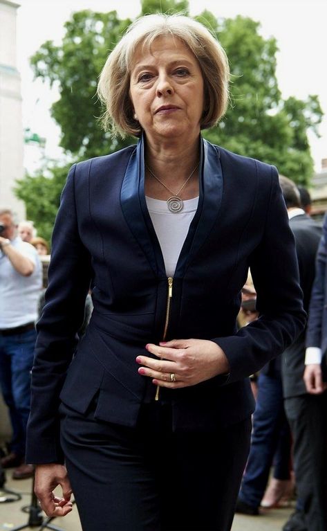 British Home Secretary Theresa May is portrayed as distinct and relatable, maintaining a connection to her original role. Female Politician, Teresa May, Housing Crisis, Emperors New Clothes, Rain Cape, British Home, Theresa May, Classic Wardrobe, British Royalty