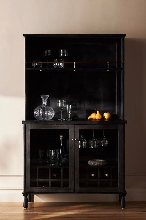 Designed by Amber Lewis in collaboration with Anthropologie, this wooden bar cabinet provides ample storage for spirits, glassware, and entertaining essentials. Glass door cabinets open to reveal sixteen storage cubes for wine bottles. Atop the cabinet, counter space and additional shelf storage make an ideal setting for mixing drinks at parties and gatherings. Amber Lewis For Anthropologie, Wooden Bar Cabinet, Home Bar Cabinet, Wine Bottle Storage, Amber Lewis, Drinks Cabinet, Glass Cabinet Doors, Wine Cabinets, Wooden Bar