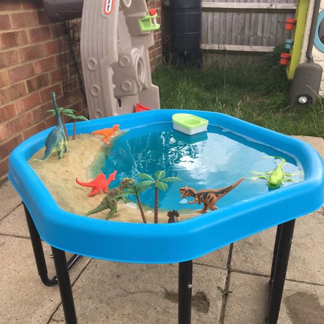 Sand, water (mixed with food dye) and dinos - what more could a dino mad child want?! Water Tray Ideas Eyfs, Summer Preschool Themes, Tuff Tray Ideas Toddlers, Kids Water Table, Tuff Tray Ideas, Beach Activity, Diy Kids Playground, Dinosaur Activities Preschool, Eyfs Activities