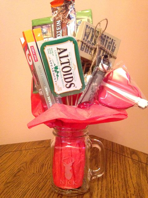 Valentine's Day gift for him! "Man Bouquet"...Gatorade chews, Altoids, chapstick, heart shaped lollipop, fish hook, protein bar and a video game. Give him something he'll love! Heart Shaped Lollipops, Man Bouquet, Protein Bar, Valentines Day Gifts For Him, Protein Bars, Fish Hook, Holiday Ideas, Lollipop, A Video