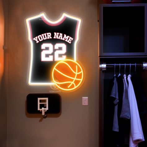 This basketball jersey neon light is the perfect choice for fans and interior decoration enthusiasts. It combines basketball elements with modern neon light technology, adding a touch of energy and dynamism to your space. The neon light is made of high-quality LED tubes, featuring high brightness and low energy consumption, ensuring a bright and soft glow in any environment. The lamp body is made of sturdy and durable materials, guaranteeing a long service life. The light comes in vibrant colors, including classic basketball orange, cool blue, and passionate red, catering to different decoration needs. It is easy to install, supporting both wall hooks and hanging methods, making it adaptable to various installation environments. Whether as a gift for basketball lovers or as an addition to Basketball Room Ideas For Boys, Room Decor Basketball, Boys Basketball Bedroom, Basketball Theme Room, Basketball Room Decor, Basketball Wall Decor, Basketball Bedroom, Sports Room Decor, Basketball Room