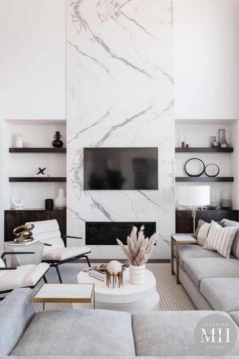 This living room is absolutely gorgeous! We love how timeless this space is! 🤍⏱ #styledbymh #omahainteriordesign #MHstyleathome #interiordesign #omaha #nebraska #omahanebraska #homedesign #homereno #livingroom #classicmodern #timeless #whitedesign #marble #fireplace #livingspace #home Modern Fireplace Ideas Living Rooms, Fireplace Modern Design, Fireplace Feature Wall, Marble Fireplace, Living Room Decor Fireplace, Omaha Nebraska, Home Fireplace, Modern Fireplace, Living Room Tv Wall