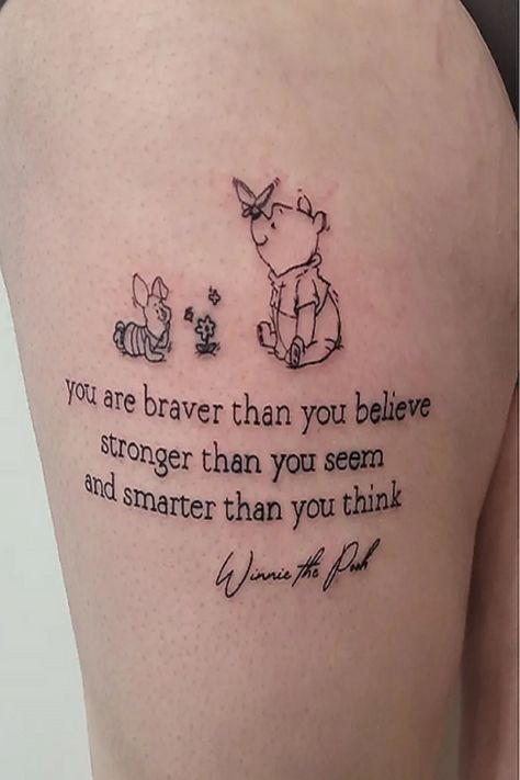 The tattoo you’ve shared features characters from Winnie the Pooh, specifically Winnie the Pooh and Piglet. The text below them reads: “you are braver than you believe, stronger than you seem, and smarter than you think.” This quote is attributed to Winnie the Pooh and serves as a message of self-encouragement and belief in one’s inner strength and intelligence. The butterfly above the characters adds a touch of whimsy. Tattoos often hold personal significance. Tiny Tattoos Winnie The Pooh, Braver Than You Believe Quote Tattoo, You Are Braver Than You Believe Tattoo, Eore Winnie The Pooh Tattoos, Tattoo Ideas Winnie The Pooh, You Are Stronger Than You Think Tattoo, Winnie The Pooh Quotes Tattoo, Pooh Bear Tattoo Ideas, Piglet Tattoo Ideas