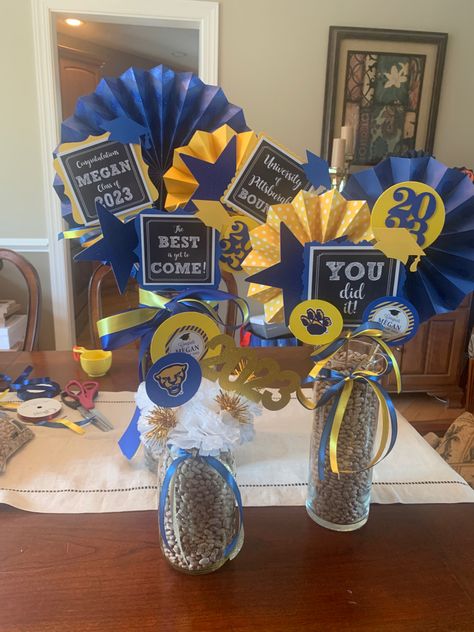 College Centerpieces Table Decorations, Homecoming Table Centerpieces, Blue White And Gold Graduation Party, Navy Blue And Gold Graduation Party Centerpieces, Blue And Gold Graduation Centerpieces, Blue And Gold Table Centerpieces, Blue Centerpieces For Party Men, Royal Blue And Gold Graduation Party, Blue And Gold Graduation Party Ideas Table Decorations