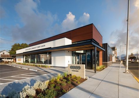 Scott Edwards Architecture partnered with Consolidated Community Credit Union to renovate their Cascade branch location. The renovation consists of numerous improvements to the member experience, including a new entry, new teller and loan officer areas, and high ceilings with clerestory windows that provide an abundance of natural light. #renovation #commercialarchitecture #bankdesign #commercialdesign #hoodriver Bank Exterior Design, Bank Building Design, Bank Exterior, Bank Architecture, Hood River Oregon, Bank Building, Strip Mall, Bank Design, Banks Building