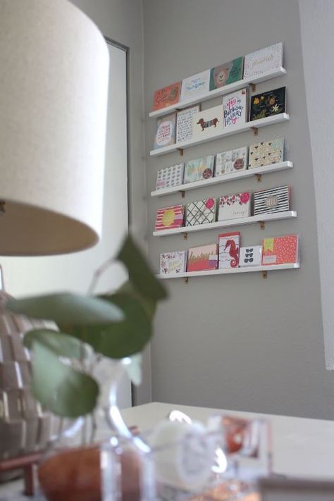 DIY Greeting Card Display Wall How To Display Greeting Cards At Home, Creative Retail Display Wall Shelves, Diy Greeting Card Display, Greeting Cards Display, Display Greeting Cards, Bus Boutique, Card Display Ideas, Greeting Card Display Stand, Postcard Display