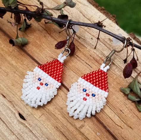 Santa Claus Earrings with Red Hat, White Beard, Blue Eyes, Red Nose and Mouth, and Silver Tone Ear Wire. Adorable for the young and old Santas out there. Happy Holidays! Red Beaded Earrings For Christmas, Beaded Santa Claus Earrings Patterns, Beaded Santa Earrings, Santa Claus Beaded Earrings, Southwestern Christmas Ornaments, Southwestern Christmas, Beaded Christmas Earrings Toocutebeads.com, Earrings 2024, Brick Stitch Pattern Earring