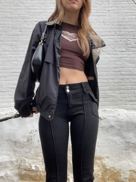 woman with medium length brown hair wearing black pants, brown shirt, and black jacket with a black purse holds onto a black leash in front of a white brick background outside Agatha Pants Outfit, Agatha Jeans, Agatha Brandy Pants, Agatha Pants, Brandy Melville Agatha Pants Outfit, Brandy Melville Black Pants, Brandy Melville Feanne Jeans, Agatha Pants Brandy Melville, Agatha Jeans Brandy Melville