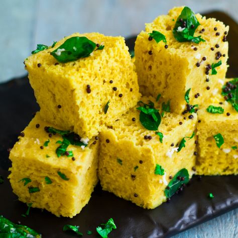 Dhokla is a nutritious Indian food with a base of fermented chickpea batter and rice. It originates from the Gujarat region, though its popularity has spread throughout India. #dhokla #tasty #snacks #indian #yummy #tasty #gujarati #gujarat Khaman Dhokla, Dhokla Recipe, Spicy Snacks Recipes, Breakfast Recipes Indian, Vegetarian Snacks Recipes, Spicy Snacks, Gujarati Recipes, Vegetarian Snacks, Indian Snacks