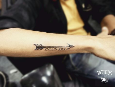 Arrow tattoo with Roman date Arrow Tattoo With Date, Date Ideas Tattoo, Roman Numeral Arrow Tattoo, Arrow Tattoo Design For Men, Arrow Tattoo Men, Mens Arrow Tattoo, Arrow Forearm Tattoo, Typographic Tattoo, Just Tattoo