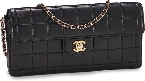 An iconic piece from the early 2000s, Chanel's structured 'Chocolate Bar' bag is crafted in black quilted lambskin leather and accented with pale gold-tone 'CC' turnlock and chain-link hardware. With a convertible drop-in chain-link and leather strap, this versatile bag can be worn over the shoulder or as a chic clutch. Black Luxury, Pale Gold, Black Quilt, East West, Luxury Store, Chocolate Bar, Lambskin Leather, Chain Link, Convertible