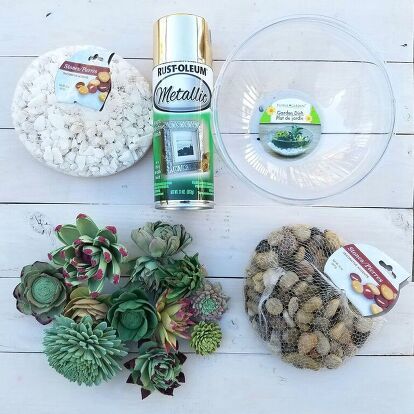 Remember those wood flower succulents we painted last week? Time to use them to create a cute succulent terrarium garden in 3 easy steps! What You'll Need:    Here is what I used:  Sola wood flowers painted as succulents  A low/short bowl. I found these plastic terrarium bowls at the Dollar Tree ($1 each!) but you can use a glass, ceramic or metal bowl as well.  Spray paint (optional)  White rocks or river rocks. These are also from the Dollar Tree.   Step 1 (Optional) - Spray paint th… Modern Garden Trellis, Barn Quilts For Sale, Flower Succulents, Plastic Terrarium, Rock Projects, Terrarium Garden, White Rocks, Vintage Metal Trays, Succulent Bowls