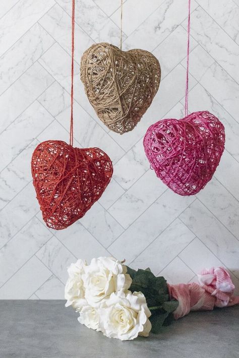 Learn how to make DIY Twine Hearts for Valentine’s Day. These decorations are easy to make! Jute twine, heart-shaped balloons and glue are the building blocks for this project. DIY Twine Hearts Project OverviewJute TwineSince I was making Valentine’s Day decorations, I used red, dark pink, and natural brown jute twine.Heart-Shaped BalloonsBecause I wanted the final decorations to be on the smaller-size, I used 6″ heart-shaped balloons that I found on Amazon. They worked great (once… Diy Heart Crafts, Valentine Wood Crafts Diy, Heart Yarn Craft, Yarn Hearts Craft, Twine Hearts Diy, Yarn Hearts Diy, Woven Heart Craft, Yarn Wrapped Hearts Valentine Day Crafts, Yarn Balloon