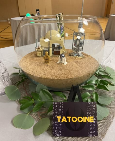 Starwars Bouquet, Guardians Of The Galaxy Centerpieces, Star Wars Terrarium Diy, Nerdy Centerpieces, Star Wars Quinceanera Theme, Lego Centerpiece Ideas Wedding, Mandalorian Wedding, Star Wars Party Centerpieces, Lego Wedding Centerpiece