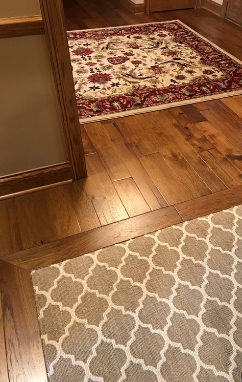 Entry rug on wood floor & carpet inlaid under a wood border in next room. Love the various sized wood planks! Wood Floor With Carpet Inlay, Carpet With Wood Floor Border, Wood And Carpet Flooring Combination, Rugs On Wood Floors, Carpet Inlay, Wood Flooring Ideas, Staining Wood Floors, Best Wood Flooring, Types Of Wood Flooring