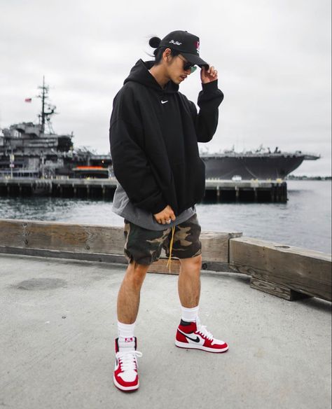 Large hoodie paired with camo shorts and Air jordans 1 mid sneakers Mens Shorts And Hoodie Outfit, Air Jordan Summer Outfit, Air Jordans Outfit Men, Style Jordan 1 Men, Hoodies And Shorts Outfit, Air Jordan 1 Mid Outfit Man, Jordan 1 With Shorts, Shorts And Jordans Outfit, Jordan High Outfit