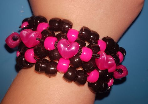 Pink and Black Kandi heart bracelet  made with pony beads and stretch cord made with the x base stitch cuff and added heart beads for decoration!  Shipping please note I am UK based - It should take 3-7 days in the UK I ship first class Royal mail For international orders it can take 7 days to 4 weeks depending on where you are located please let me know if you have a deadline date. Kandi Heart, X Base Cuff, Heart Bracelet Pattern, Bracelets Kandi, Pulseras Kandi, Kandi Cuff Patterns, Diy Kandi Bracelets, Diy Kandi, Kandi Kid