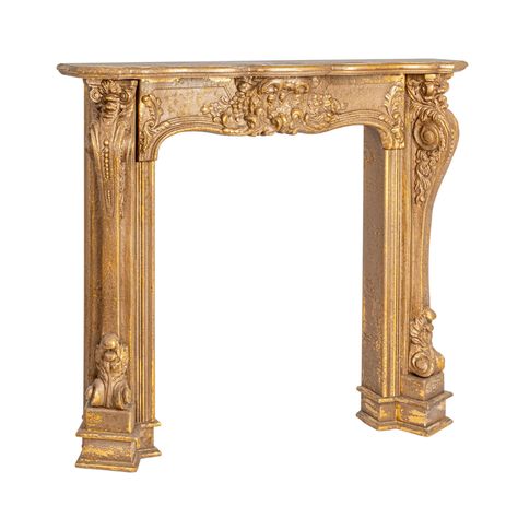 PRICES MAY VARY. Wood An exquisite distressed gold fireplace mantel surround that radiates Victorian elegance A stately addition to any room, embodying the grandeur of antique, traditional, or French Country lifestyle Ideal for framing the heart of the home, this mantel surround is a luxurious focal point for living spaces Embellished with magnesia, known for its stone-like appearance and durability, with a lavish gold finish 55.1” L x 10.9” W x 48.4” H Mantle Over Wood Stove, Anthropologie Fireplace, Mantle No Fireplace, Country Victorian Decor, Fireplace Updates, Gold Fireplace, French Country Fireplace, Ornate Fireplace, Fireplace Renovation