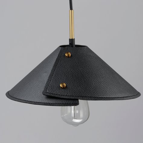 Expertly stitched leather shades are bound by brass finials in a folded shape that is radially asymmetric. These black leather shades obstruct LED lamping to create ambient indirect lighting and pair well with the Naturally Aged Brass frames that feature a smooth, chestnut leather wrap detail. The shades on the expansive two-light pendant are adjustable to provide function on its oversized width perfectly chic over a dining table, bar, or kitchen island. The wall sconce option is designed for bo Lamp On The Wall, Leather Chandelier Light Fixtures, Leather Table Lamp, Leather Light Fixture, Leather Lamp Shade, Leather Pendant Light, Leather Lamps, Leather Lighting, Leather Chandelier