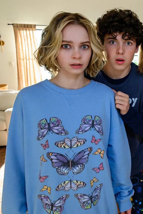 Netflix 'Family Switch': Where to Get All the Outfits — Femestella Retro Bike Helmet, Butterfly Sweatshirt, Black Pleated Mini Skirt, Emma Myers, Fair Isle Cardigan, Beaded Sweater, Olivia Black, Jennifer Garner, Wednesday Addams