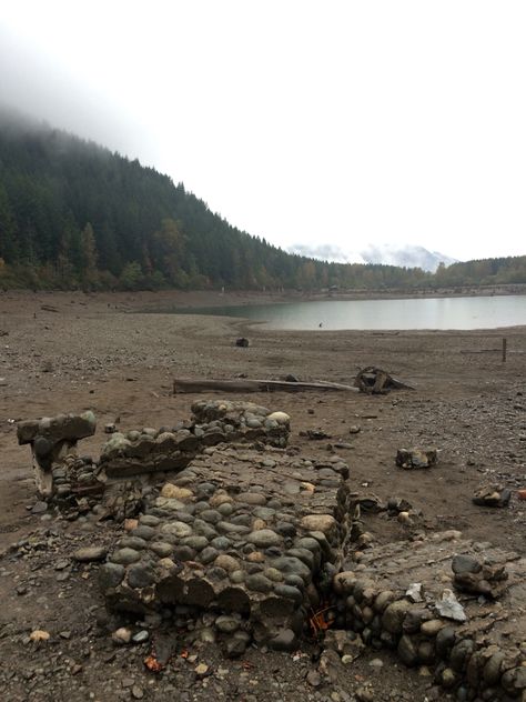 Old stone chimney on the bottom of Rattlesnake Lake in Northbend Washington is visible because of drought conditions. 100 years ago the town of Moncton was flooded by rising waters caused by the filling of a dam...on a ridge to the east! Water permeated the land and swallowed up the town! Stone Chimney, 100 Years Ago, Bucket List Destinations, Old Stone, Vintage Pictures, Washington State, The East, The Land, 100 Years