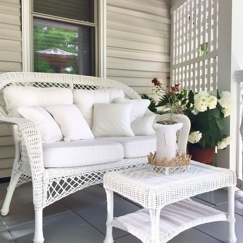 White wicker sofa with cushions and flowers on a serene home porch Tranquil Home, Wicker Couch, Wicker Table, Wicker Sofa, Home Porch, White Wicker, Cozy Home, Porch Decor, Blooming Flowers