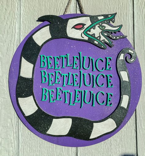 "This is an 18\" round Beetlejuice door hanger, or wall decor. made from 1/4 inch birch. hand painted and finished with a clear sealer to help the product last longer. You can opted out on the glitter." Painted Round Door Hangers, Beetlejuice Sign Diy, Beetlejuice Classroom Door, Beetlejuice Door Hanger, Beetlejuice Door Decoration, Beetlejuice Door, Beetlejuice House, Beetlejuice Characters, Halloween Boards