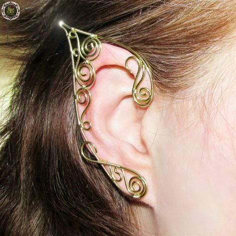 Elevate your fantasy-inspired style with these enchanting elf ear earrings. Handcrafted with precision and care, these earrings are a perfect addition to your elven-inspired jewelry collection. Made with non-tarnish gold plated wire, they gleam with a captivating and timeless golden allure. Key Features: ✨ Golden Swirls: Each earring is delicately adorned with intricate golden swirls that exude elegance and mystique. 🌟 Non-Tarnish Gold Plated Wire: Crafted to last, our earrings are made with high-quality gold plated wire, ensuring they maintain their radiant shine over time. ✨ Elfish Elegance: These earrings are designed to gracefully mimic the pointed ears of elves, adding an ethereal touch to your look. 🌟 Versatile: Whether you're attending a fantasy event, cosplay convention, or simpl Wire Elf Ears, Elven Costume, Elf Jewelry, Ears Jewelry, Elf Cosplay, Elf Ear Cuff, Fairy Ears, Elven Jewelry, Fantasy Gifts