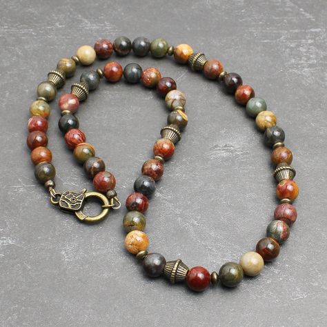 "* Made with Red Creek Jasper 8mm round beads, which has the earthy multi-colors of tan, olive green, burnt red, charcoal gray, and more. The softly muted colors of this natural stone makes it great for both men and women. * Embellished with antiqued brass finish pewter beads and brass spacers. It closes with an unique looking lobster clasp in antiqued brass finish pewter. * Strung with a professional quality durable wire, which is made of 49-strand fine stainless steel bundled and nylon coated. Bead Necklace For Men, Red Creek Jasper, Earthy Jewelry, Natural Stone Jewelry, Funky Jewelry, Jewelry Lookbook, Hippie Jewelry, Necklace For Men, Jewelry Inspo