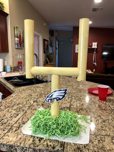 I made this football field goal from things around my house! The goal is made from paper towel rolls spray painted yellow. The base is a styrofoam square with Easter grass glued to it. Super Bowl party decor, DIY, football party. Philadelphia Eagles party. Eagles Party Decorations, Philadelphia Eagles Snacks, Philadelphia Eagles Decorations, Eagles Theme Birthday Party, Philadelphia Eagles Party Decorations, Diy Philadelphia Eagles Decor, Eagles Party Ideas Philadelphia, Philadelphia Eagles Birthday Party Ideas, Football Decorations Diy