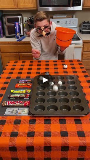 the Halloween Muffin Pan Challenge 🧁 | the Halloween Muffin Pan Challenge 🧁  Kids, Dad, Mom, and family play diy halloween game with ping pong balls and muffin tin at the kitchen table for... | By Family games fanFacebook Muffin Tin Game, Turkey Olympics, Halloween Muffin, Ping Pong Games, Pong Game, Games To Play With Kids, Diy Halloween Games, Halloween Games For Kids, Ping Pong Balls