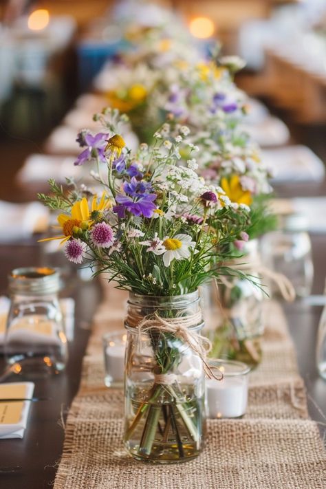 Transform your wedding tables into a storybook scene with our antique book centerpieces! 📚💒 Delicate lace runners and warm votive candles complete the romantic ambiance. Perfect for bibliophiles saying I do! #WeddingInspiration #VintageWedding #BookLover #RomanticDecor #WeddingIdeas #Candlelight #AntiqueChic #LaceDetails Let the love stories of old add charm to your special day! Rustic Farm Wedding Table Decor, Wildflower Wedding Table Setting, Simple Wildflower Centerpieces, Wild Flower Table Decorations, Wildflower Wedding Florals, Wildflower Centrepiece, Wildflower Wedding Table Decor, Rectangle Table Centerpieces Wedding, Sunflower Wedding Table