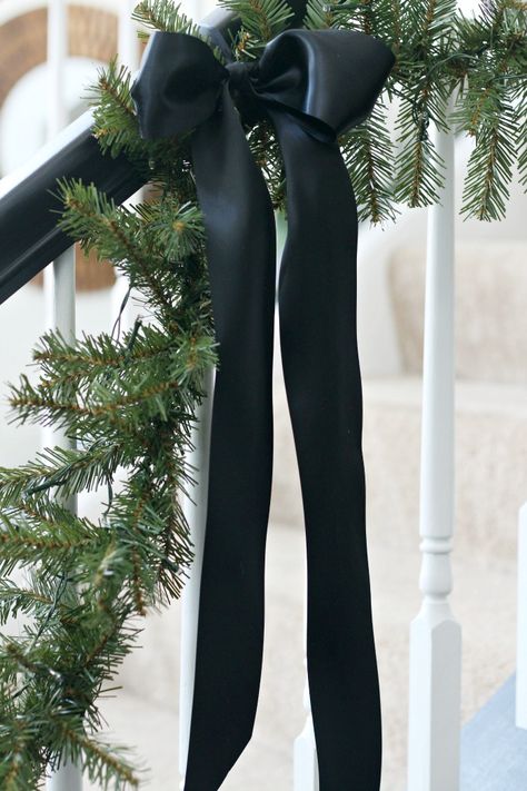 Simple and Elegant Christmas Living Room | This is our Bliss Black Garland Christmas, Black Bow Christmas Decor, Christmas Tree Black Ribbon, Handrail Christmas Decor, Black Bows On Christmas Tree, Black Velvet Ribbon Christmas Tree, Christmas Tree Bow Ideas, Black Bow Christmas Tree, Black Ribbon Christmas Tree