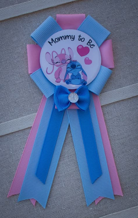 "This mini sized Lilo and Stitch Baby Shower Corsage measures approximately 3 1/2\" x 5\" with a 1 1/2\" bar pin is attached to the back.  An epoxy resin covers the center image. We can make any recipient... just order the number you need and then leave us a note in the \"note to seller\" section at checkout telling us who the recipients are (ie: Mommy to Be, Daddy to Be, Grandma to Be, etc).  This is a super cute way to identify everyone at the shower and make them feel special!   All our items are shipped on pretty corsage cards and wrapped in pretty tissue... perfect for gift giving! All items are shipped in mailing boxes to ensure they stay perfect during their travels to you! We love custom work!  Please ask us if there is something special we can create for you!" Stitch Theme Nursery, Baby Shower Stitch Theme, Gender Reveal Ideas Lilo And Stitch, Stitch Baby Shower Theme Girl, Baby Stitch Baby Shower Ideas, Stitch And Angel Baby Shower Ideas, Stitch Pregnancy Announcement, Stitch Themed Baby Shower Ideas, Lilo And Stitch Baby Shower Theme