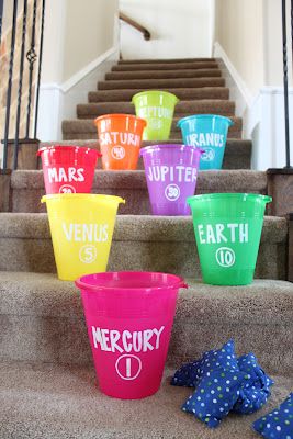 Game: a fun planet toss on the stairs with bean bags and buckets. Space Vbs, Planet Party, Eclipse Party, Rocket Party, Space Week, Astronaut Party, Space Unit, Space Theme Party, Outer Space Party