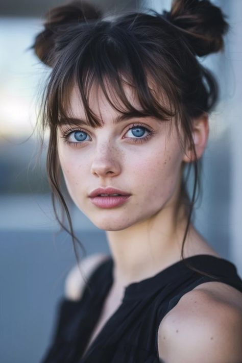 Young woman with blue eyes and freckles, hair in double buns, looking intently at the camera. Space Buns Art Reference, 2 Buns With Bangs, Futuristic Hairstyle, Space Buns With Bangs, Two Bun Hairstyles, 90 Hairstyles, Space Bun Hair, Space Buns Hairstyles, Double Buns Hairstyle