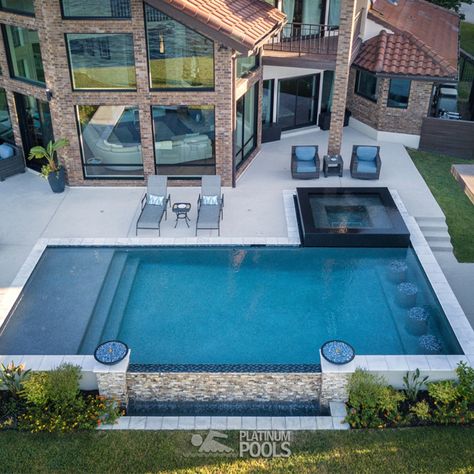 This beautiful pool has a tanning ledge with gushers, an infinity edge, and a reflective spa. Also, the concrete paver decking around the pool provides space for seating and lounging areas. Lastly, an outdoor structure offers a perfect space for an outdoor kitchen and a gathering area. The project is the recipient of the 2019 World Best Pool Award by Pebble-Tec.
Designer - Ian Espada
Builder - Platinum Pools, Houston, TX Swimming Pools Ideas, Pools Ideas, Backyard Swimming Pool, Pool Party Ideas, Kleiner Pool Design, Rectangle Pool, Dream Backyard Pool, Pools Backyard Inground, Swimming Pool Landscaping