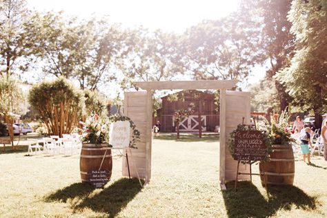 #wedding #weddingceremonydecor #weddingceremonyideas #weddingideas #summerweddings #barnwedding #junewedding #ceremonydecor #summerwedding #weddings #barnweddings #weddingceremony #flowers #welcomesign #welcome #pickaseatnotaside #ceremonyaisle #weddingaisle #aisle #unplugged #unpluggedceremony Rustic Door Wedding Entrance, Ceremony Doors Entrance, Outdoor Wedding Doors, Barn Door Wedding, Country Wedding Signs, Ceremony Entrance, Wedding Diys, Wedding Doors, Wedding Entrance